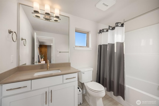 bathroom with shower / bath combination with curtain, vanity, and toilet