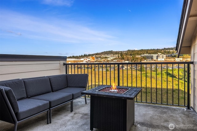 balcony with an outdoor living space with a fire pit