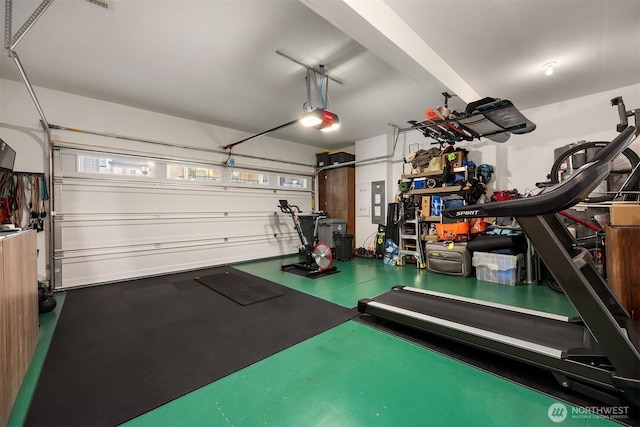 workout room featuring a garage and electric panel