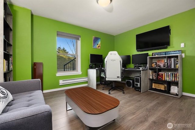 home office with baseboards, a baseboard heating unit, and wood finished floors