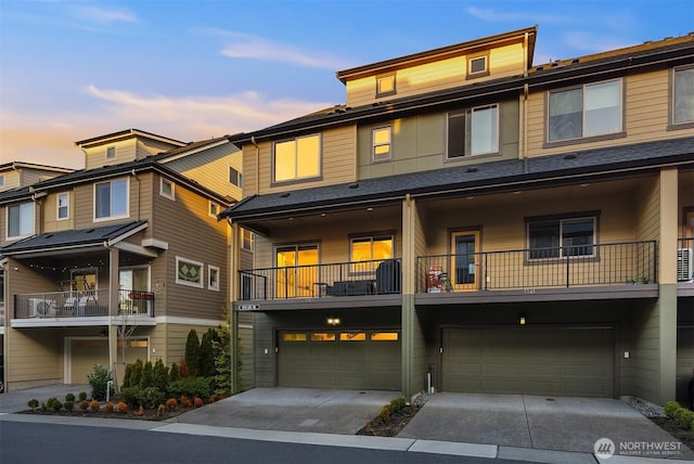 townhome / multi-family property featuring a garage and driveway