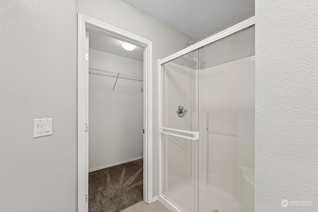 bathroom featuring a shower with shower door