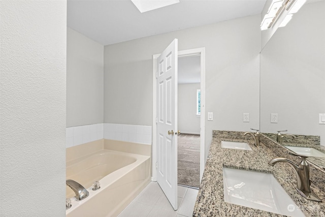 bathroom featuring tile patterned floors, vanity, and a bathtub