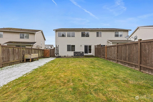 rear view of house with a yard