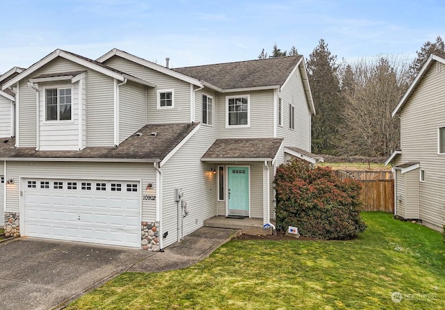 front facade with a garage and a front lawn