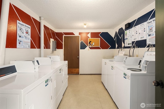 common laundry area featuring light floors, a textured ceiling, and washer and dryer