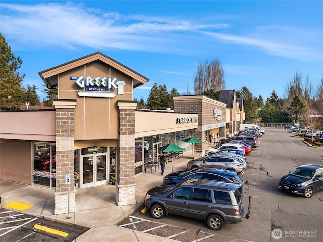 view of building exterior featuring uncovered parking