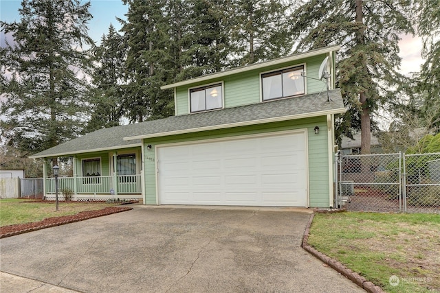 front of property with a garage, covered porch, and a front lawn