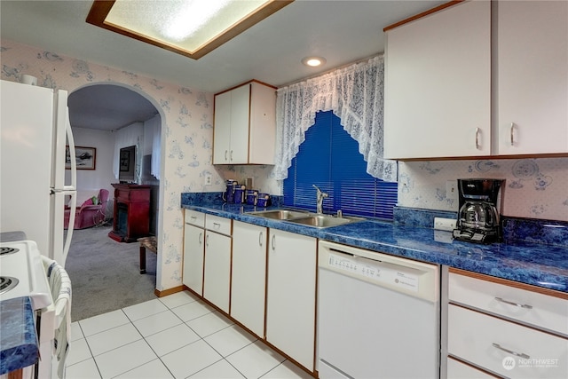 kitchen with light carpet, sink, white appliances, and white cabinets