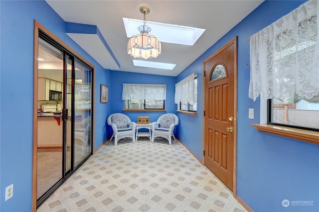 foyer entrance with a skylight