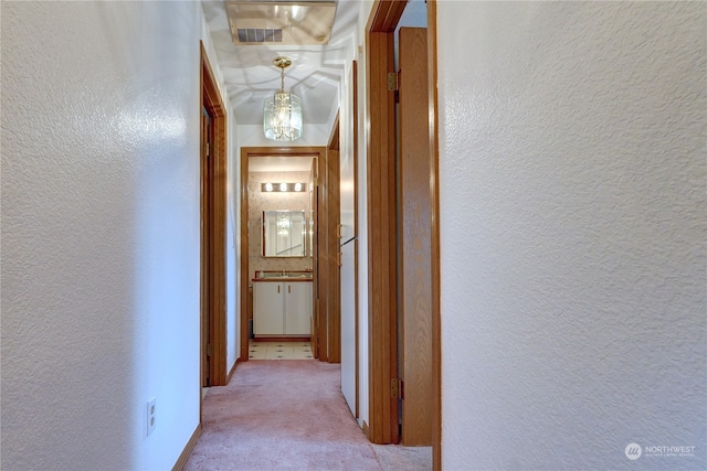 hall featuring light colored carpet