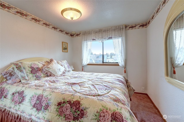 carpeted bedroom with a textured ceiling