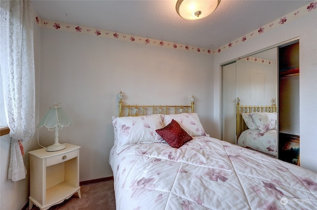 bedroom with a closet, a textured ceiling, and carpet