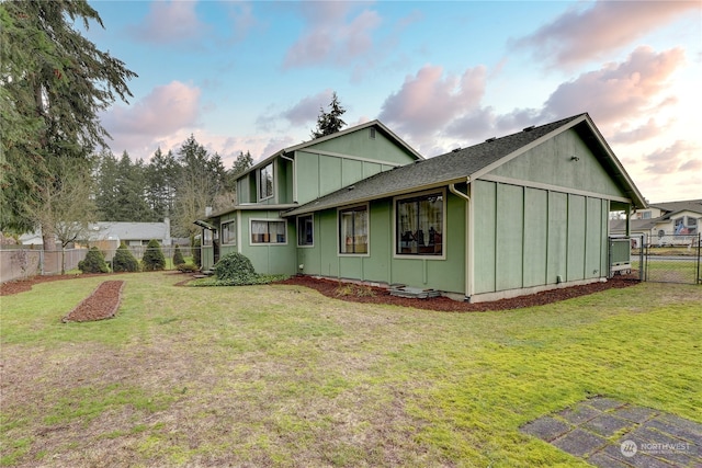 property exterior at dusk with a yard