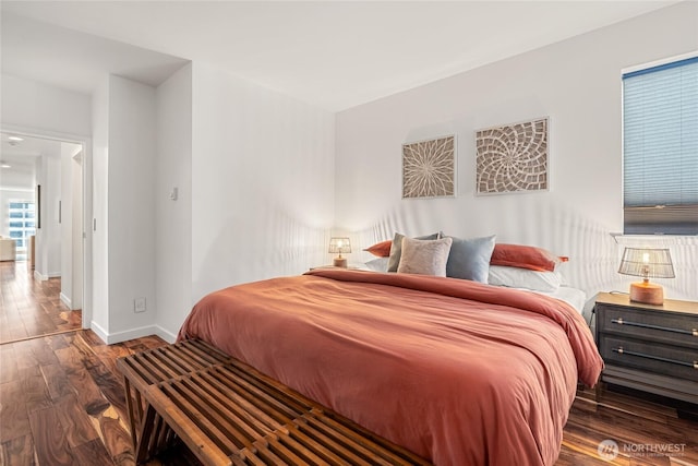 bedroom featuring wood finished floors and baseboards