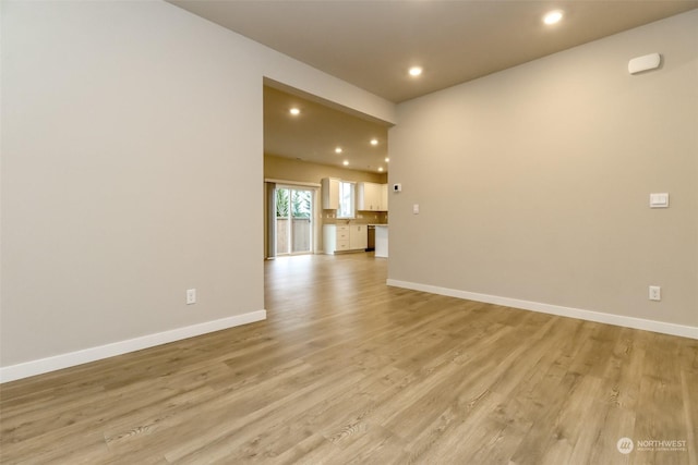 spare room with light hardwood / wood-style flooring