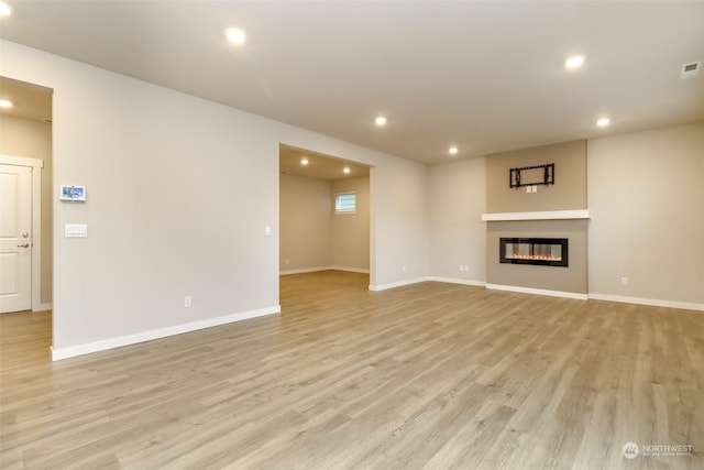 unfurnished living room with light hardwood / wood-style floors