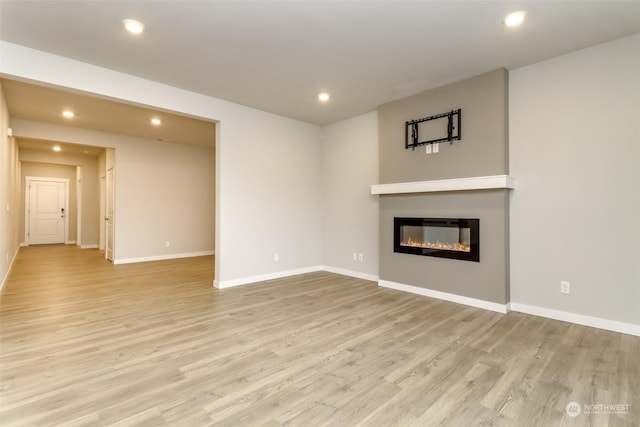 unfurnished living room with light hardwood / wood-style flooring