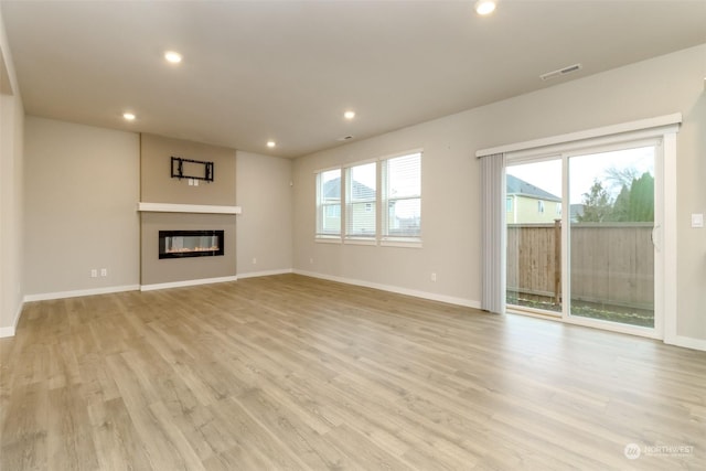 unfurnished living room with light hardwood / wood-style flooring