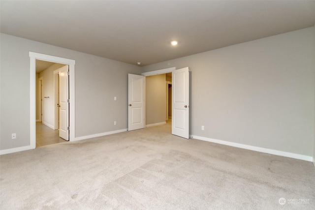 empty room featuring light colored carpet