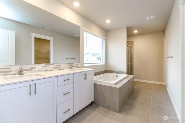 bathroom with vanity, independent shower and bath, tile patterned flooring, and decorative backsplash