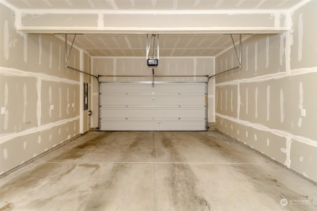 garage with a garage door opener and electric panel