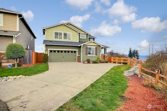 craftsman-style house featuring a garage and a front yard