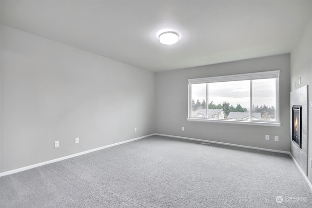 unfurnished room with carpet flooring