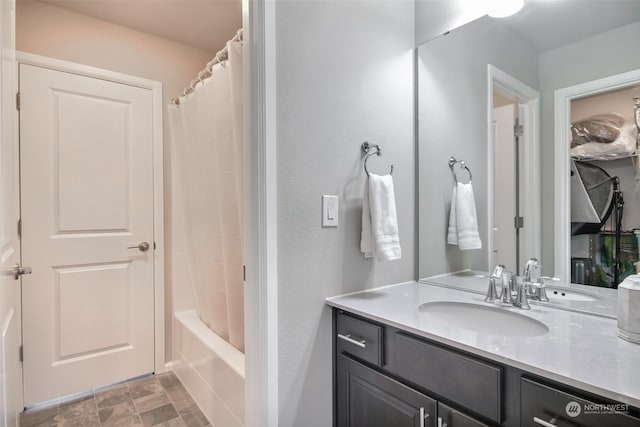 bathroom featuring vanity and shower / bathtub combination with curtain