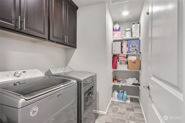 washroom featuring cabinets and washer and dryer