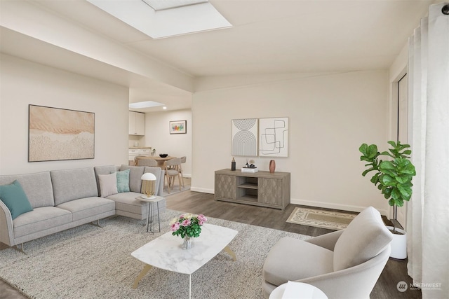 living room featuring dark wood-type flooring and a skylight