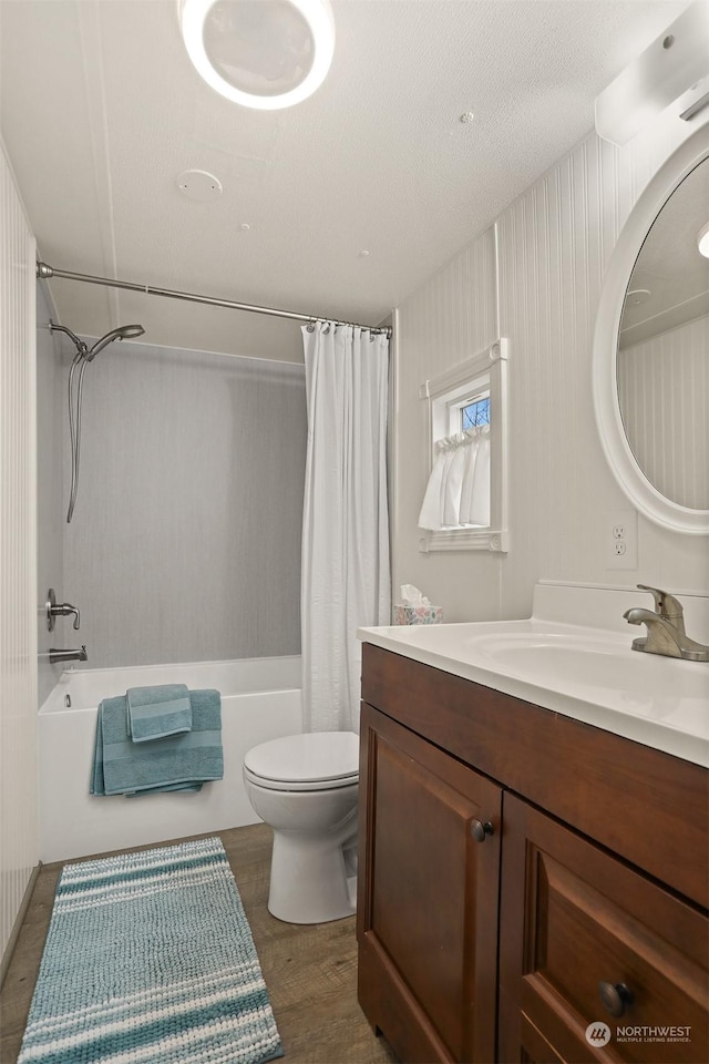 full bathroom featuring hardwood / wood-style flooring, toilet, vanity, and shower / bath combo with shower curtain