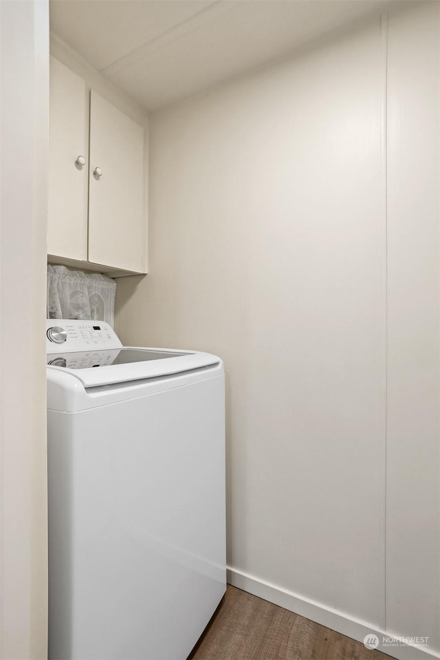 laundry area with cabinets, washer / dryer, and dark hardwood / wood-style floors