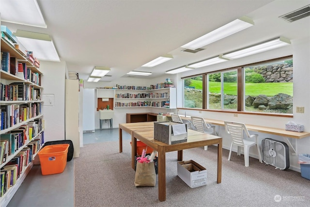 home office with concrete flooring and built in desk