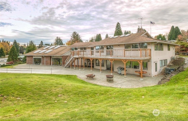 back of property with a yard, a deck, and a patio