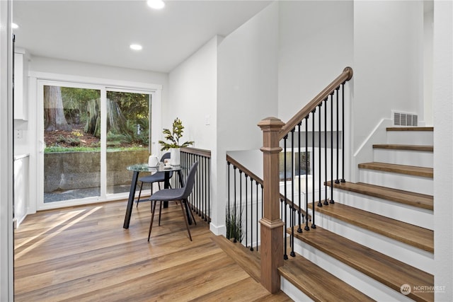 stairs with hardwood / wood-style flooring