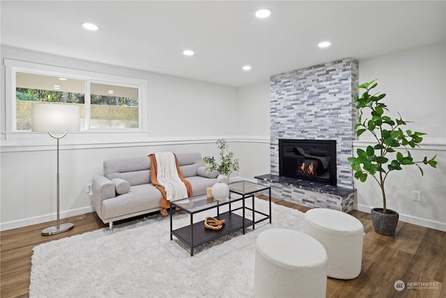 living room with hardwood / wood-style flooring and a fireplace