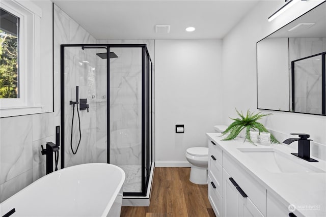 full bathroom with vanity, hardwood / wood-style flooring, plus walk in shower, and toilet