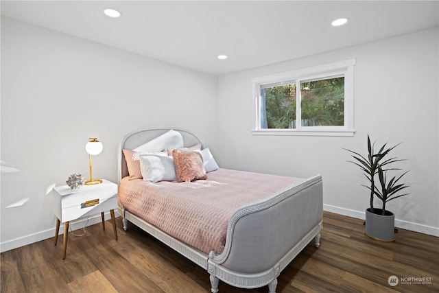 bedroom with dark hardwood / wood-style flooring