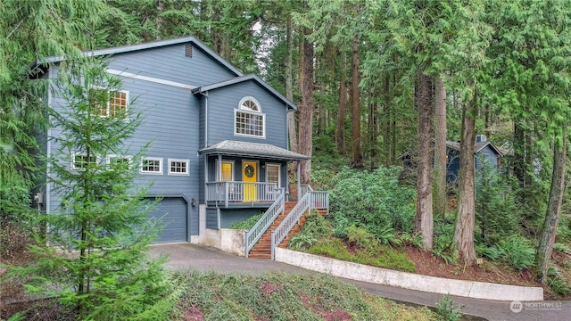 front facade featuring a garage and covered porch