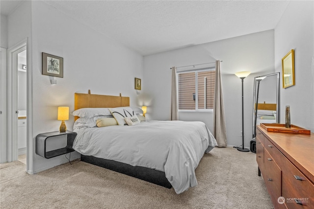 bedroom with light carpet and a textured ceiling