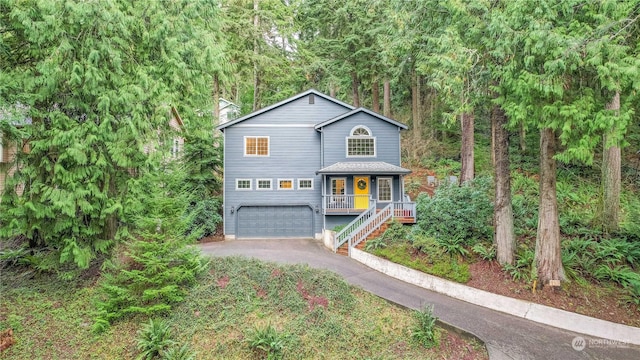 view of property with a garage and covered porch