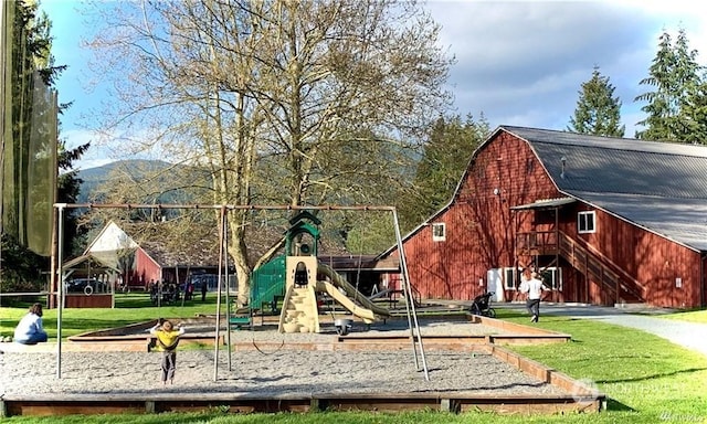 view of playground with a mountain view and a yard