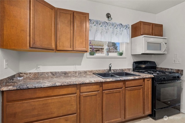 kitchen featuring black gas range and sink