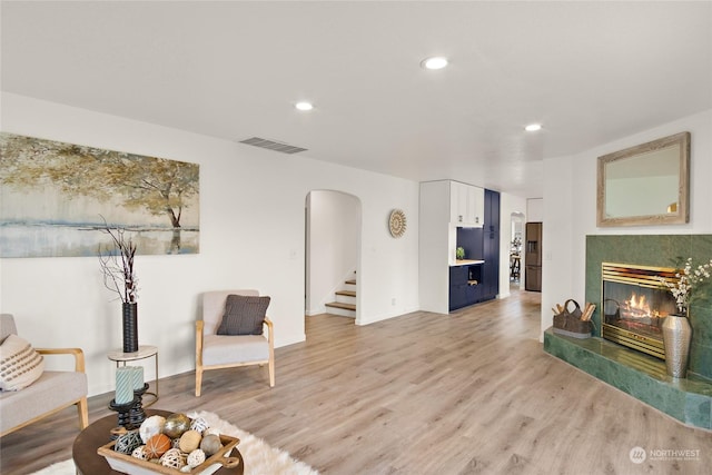 living area featuring a fireplace and light hardwood / wood-style floors