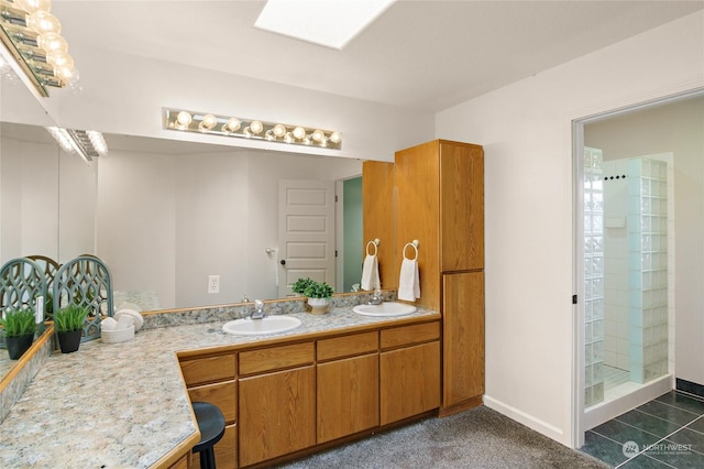 bathroom with vanity, a skylight, and walk in shower