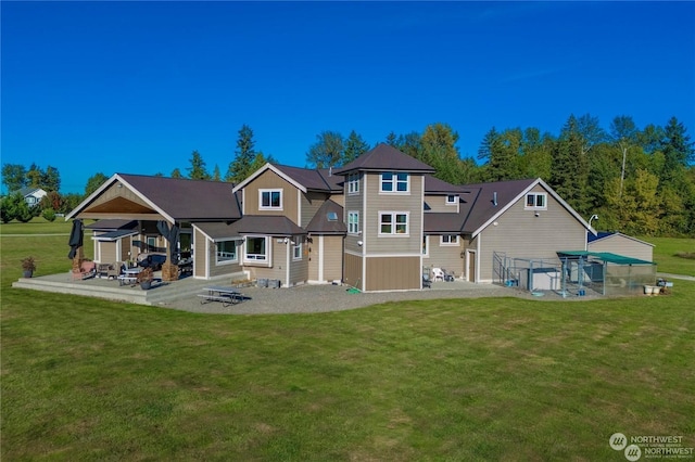 back of property with a lawn and a patio