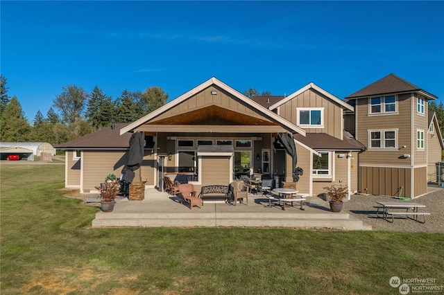 back of property with a patio area and a lawn