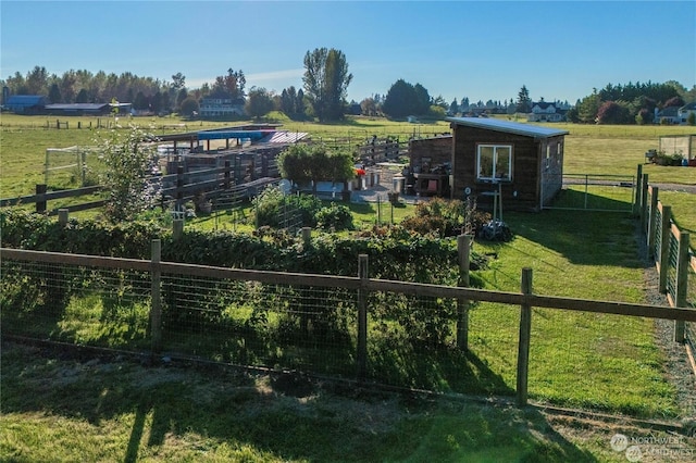 view of yard featuring a rural view and an outdoor structure