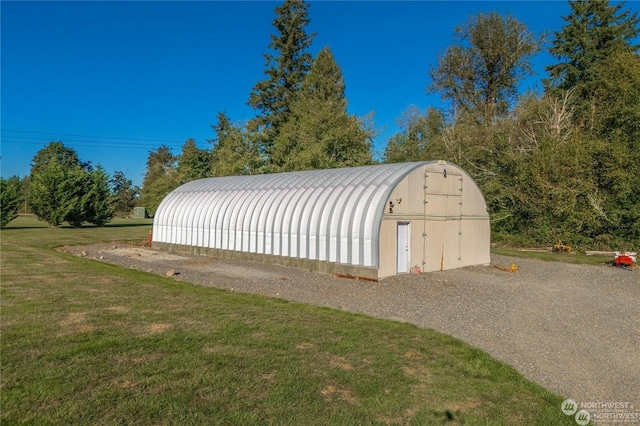 view of outbuilding with a yard